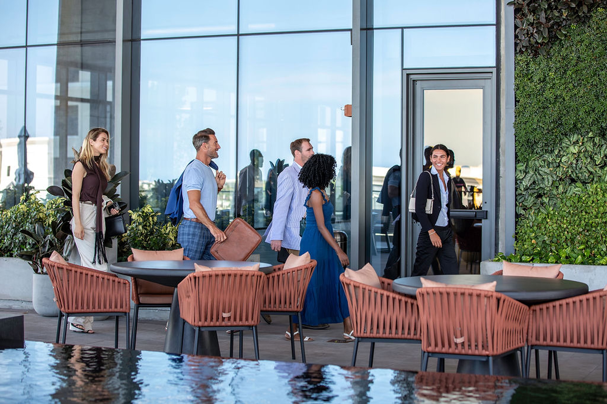 Friends arriving at a rooftop terrace overlooking the city